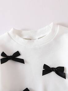 SHEIN Bộ đồ len dệt kim cổ tròn tay dài có nơ trang trí dễ thương cho bé gái và quần len ống loe lưng chun, giản dị và đáng yêu, mùa thu/đông - Đen và trắng - Xem 5