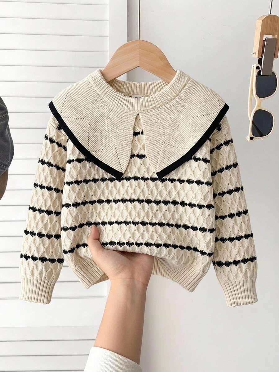 SHEIN Vintaside Kids 少女套头衫,秋冬时尚新品。奶油色、杏色和黑色条纹针织面料,柔软甜美。宽领口设计展现活泼气息,充满感觉。袖口精致华丽。适合秋冬穿着。面料质感强,柔软亲肤,轻盈舒适,温暖舒适,给小女孩带来更多舒适感。适合各种场合,展现好学女孩的优质风范,适合居家休闲、校园聚会、节日和派对。 - 米色 - 查看 1