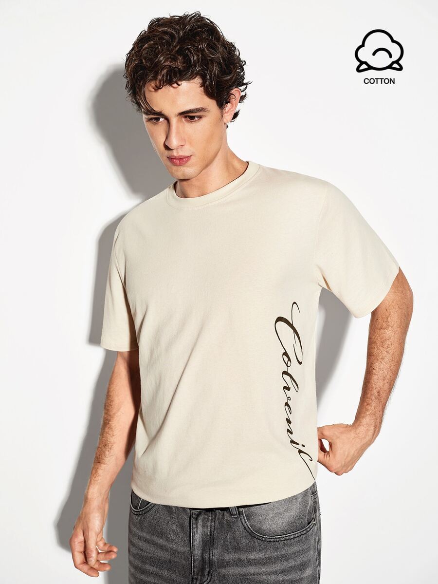COLVENIC Apricot Drop Shoulder Short Sleeve T-Shirt For Men, Side Vertical Handwritten Cursive Letter Print, Loose Fit Pure Cotton Casual Half Sleeve