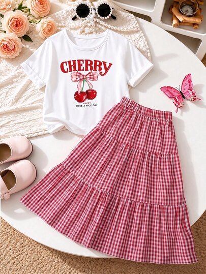 SHEIN Conjunto de camiseta de manga corta con cuello redondo, estampado de letra de cereza y decoración de lazo grande + falda larga a cuadros con decoración de botones para niñas, casual, verano