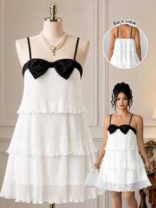 Rometta Plus Size Women's Spaghetti Strap Dress With Triple Layer Pleated Design And Prominent Black Bow On The Chest - White - View 1