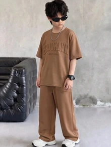 SHEIN 2pcs/Set Tween Boys' Brown Summer Casual City Break College Style Big Letter Embossed Graphic Round Neck Short Sleeve T-Shirt And Pants Sports Set - Coffee Brown - View 3