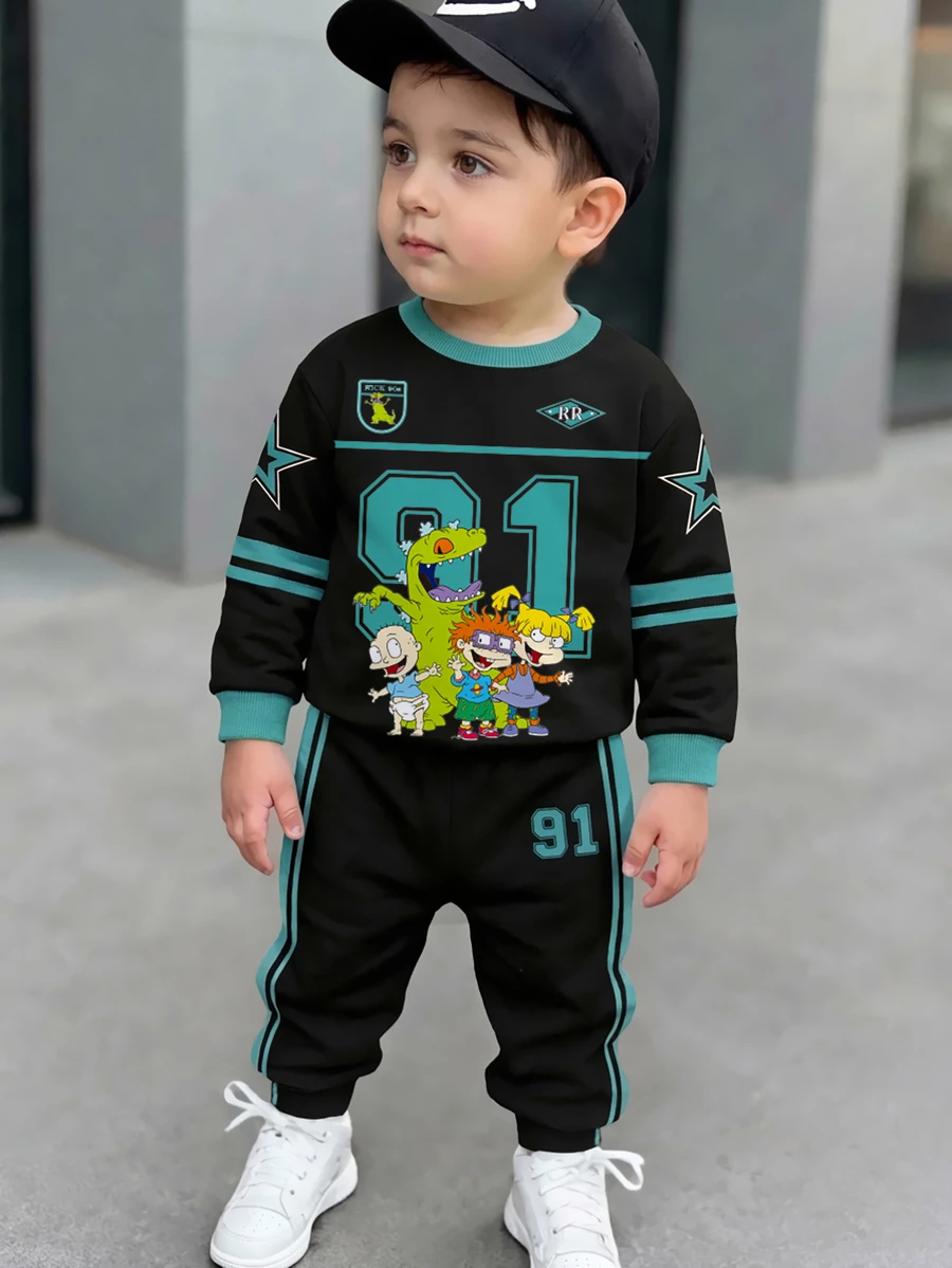 Nick 90s | SHEIN Nick 男童幼兒淘氣士兵卡通印花 2 件套,圓領長袖衛衣 Star 91 圖案,側條紋長褲,休閒套裝 藍色 - 黑色 - 查看 1