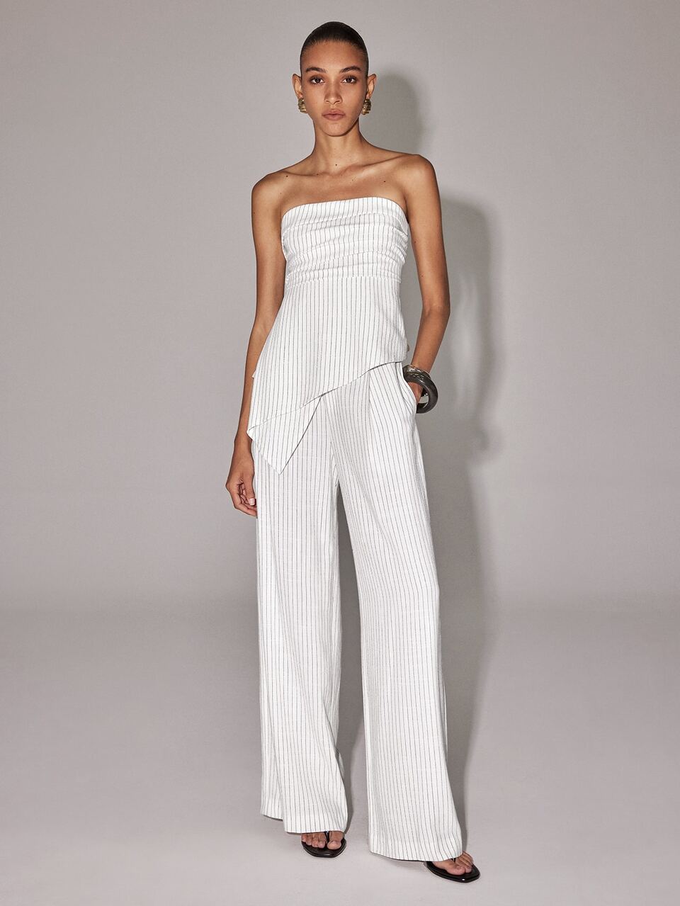 Anewsta New Spring/Summer White Base Fine Vertical Striped Bandeau Set, Urban Women's Ruched Asymmetrical Top And High-Waisted Pleated Wide-Leg Pants Two Pieces Set, Relaxed Old Money Style, Urban Vacation, Cool Atmosphere, Suitable For Commuting, Dating, Gathering, Travel, Vacation, Store Visiting, Light Social Occasions
