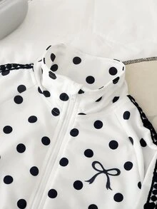 SHEIN Elladie kids 女童波點兩件套，白色底色配黑色波點印花，拉鍊開襟外套左側飾有黑色蝴蝶結印花，長褲配同款波點印花與鬆緊收口褲腳，袖口與褲腿飾有織帶飾邊，適合日常上學、社區散步、戶外出遊、購物與旅行 - 黑與白 - 查看 9