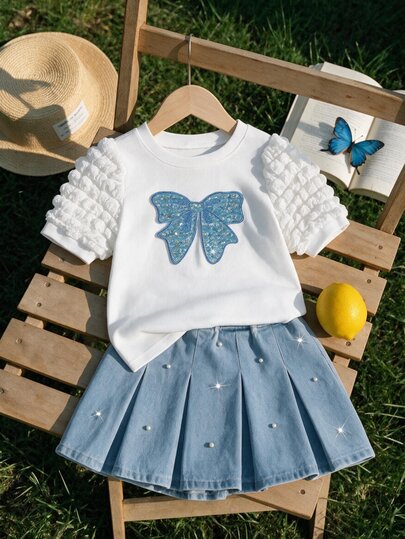 SHEIN Girls' Sweet Bow Top And Denim Mini Skirt 2-Piece Set, Summer New Arrival, Cute Girly Style, Light Blue Denim, Pearl Embroidery, Puff Sleeves, Elastic Waist, Umbrella Skirt, Soft Skin-Friendly, Versatile For Daily Wear, School, Party, Vacation, Children's Day, Summer Outfit, Girly Era Elegant Set
