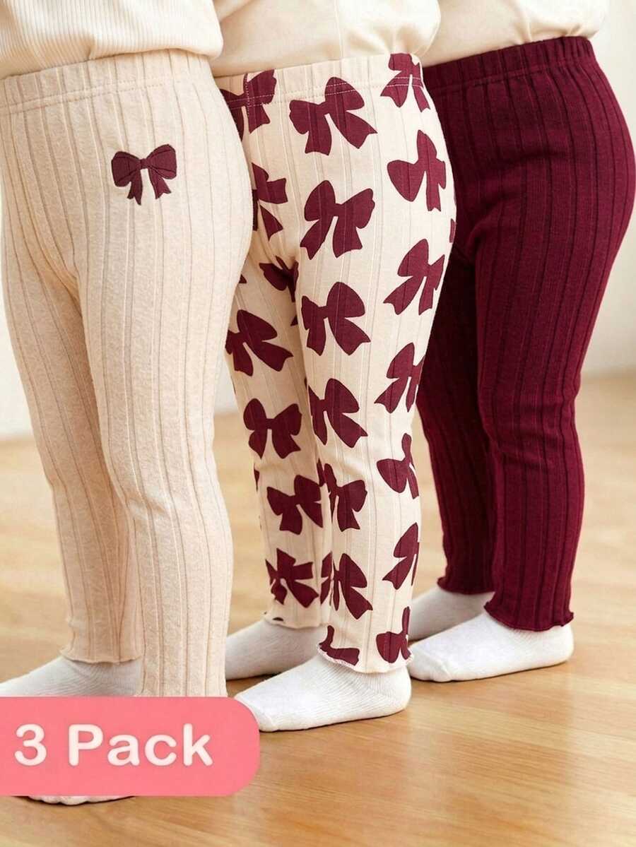 SHEIN Vintaside Kids مجموعة 3 قطع بنطلون ليقنز مضلع للبنات الرضع، بتصميم حلو وجميل، لون مشمشي وبورغندي، بطبعة فيونكة، خصر مطاطي، مناسبة لعيد الميلاد والحفلات والعطلات والخريف - متعدد الألوان - مشاهدة 1