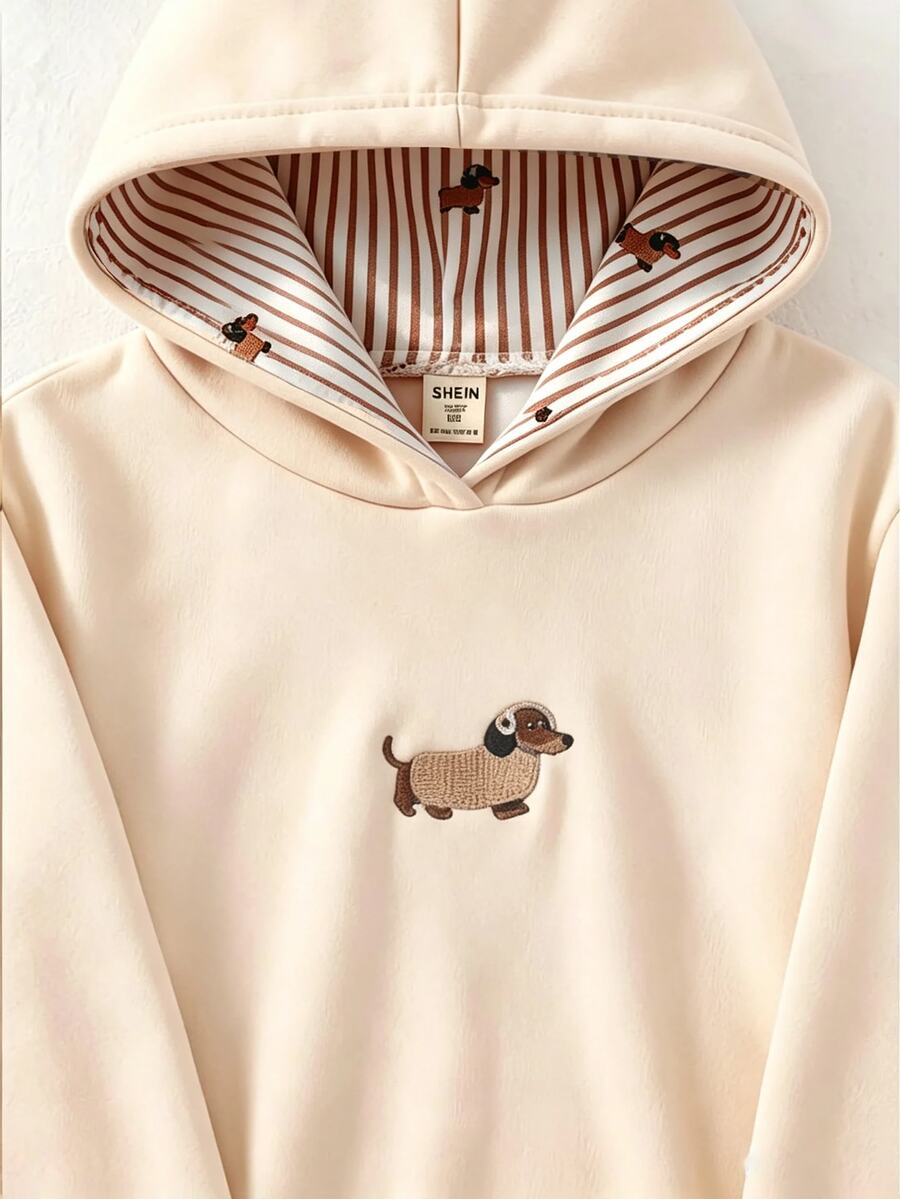 SHEIN 女童軟萌甜美杏色連帽衛衣，寬鬆舒適，胸前印有臘腸犬幼犬圖案，連帽內側配對幼犬印花，簡約百搭日常出遊校園穿搭，中厚度保暖內裡加厚毛絨，秋冬款 1 件 - 杏色 - 查看 1