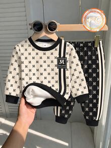 Young Boys Sweatshirt Set, Top With Beige Base Color, All-Over Black M Letter Print, Double Black Vertical Stripes Decoration On Sides, Square M Logo, Black Ribbed Collar And Cuffs, Matching Long Pants With Black Base Color, All-Over M Letter Print, Double White Stripes On Sides, Ribbed Cuffs - Multicolor - View 1