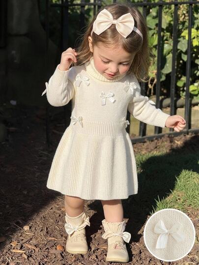 SHEIN Infant/Toddler (Girl) Apricot Knit Sweater Dress With 3D Bow, High Neck, Round Neck, Pullover, Regular Shoulder, Long Sleeve, Soft And Comfortable, Suitable For Daily, Outing, Travel, Vacation, Home, And Daycare Scenes