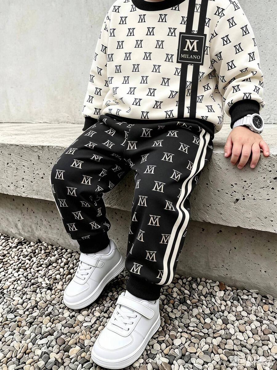 Setelan Sweatshirt Anak Laki-Laki, Atasan dengan Warna Dasar Krem, Cetakan Huruf M Hitam di Seluruh Permukaan, Dekorasi Garis Vertikal Ganda Hitam di Sisi, Logo M Persegi, Kerah dan Manset Bergaris Hitam, Celana Panjang Serasi dengan Warna Dasar Hitam, Cetakan Huruf M di Seluruh Permukaan, Garis Putih Ganda di Sisi, Manset Bergaris - MultiWarna - View 1