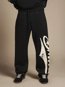 SUMWON Pantalon de jogging en molleton noir à jambes larges avec imprimé logo graffiti surdimensionné sur la jambe, motif étoile et design script crème usé - Noir - Voir 1