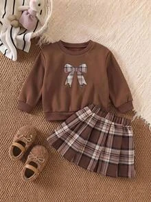 SHEIN طقم ملابس للبنات الرضع من الصوف الناعم السميك مع فيونكة زخرفية وطبعة مربعات، بلوزة سويت شيرت بياقة دائرية & تنورة خريفية مطوية بطبعة مربعات عتيقة، مناسب للشتاء - بني - مشاهدة 7