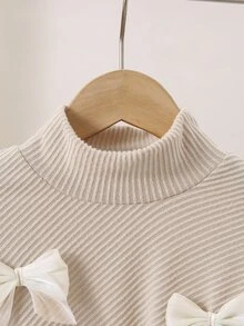 SHEIN (Young Girl) 秋冬休閒 T-shirt 套裝，設計感不對稱套頭高領淺杏色針織羅紋刷毛布料，正面白色 3D 蝴蝶結裝飾長袖上衣，搭配淺杏色純色休閒喇叭長褲，2 件套，適合秋冬返校季，優雅淑女高端日常校園、外出、旅行、派對穿著 - 杏色 - 查看 8