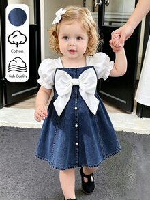 SHEIN Playful Pals 女嬰泡泡袖短袖蝴蝶結牛仔洋裝，方領設計，搭配白色編織布短袖泡泡袖，經典藍色牛仔收腰洋裝，胸前白色大蝴蝶結裝飾，正面優雅精緻白色珍珠裝飾鈕扣，A字裙，適合女嬰可愛俏皮、休閒時尚、舒適通勤穿著，適用日常度假、參加派對與節日，適合派對穿搭、實用時尚、島嶼風、海灘週末、夏季穿著 - 藍色 - 查看 4