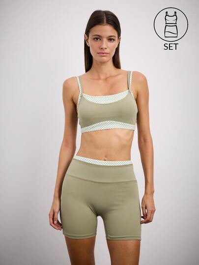 Nöista Sage Green Sports Set With A Fitted Crop Top And High-Waisted Biker Shorts, Featuring Polka Dot Trim. Chic, Sporty Style For Gym And Casual Looks.