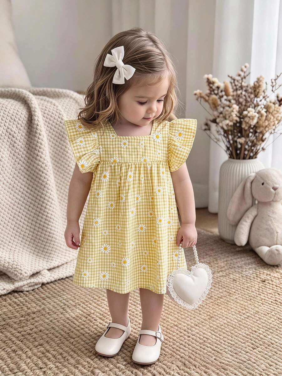 SHEIN Sweet And Lovely Daisy-Print Yellow-And-White Gingham Dress With Ruffled Flutter Sleeves And Princess-Style Hem For Baby Girls – New Arrival.