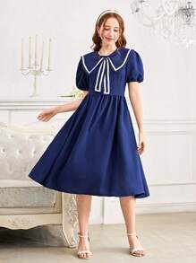 Vestido elegante y dulce con decoración de lazo en el cuello azul marino, de longitud media, con cintura ajustada y mangas cortas. Vestido de línea A ajustado a la cintura y de largo hasta la pantorrilla para chicas adolescentes.