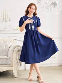 Vestido elegante y dulce con decoración de lazo en el cuello azul marino, de longitud media, con cintura ajustada y mangas cortas. Vestido de línea A ajustado a la cintura y de largo hasta la pantorrilla para chicas adolescentes.