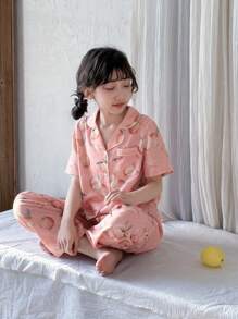Conjunto de pijama de 2 piezas con pantalón y top de manga corta con bolsillo con botones y cuello tipo polo en color melocotón para niñas preadolescentes