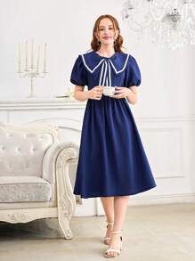 Vestido elegante y dulce con decoración de lazo en el cuello azul marino, de longitud media, con cintura ajustada y mangas cortas. Vestido de línea A ajustado a la cintura y de largo hasta la pantorrilla para chicas adolescentes.