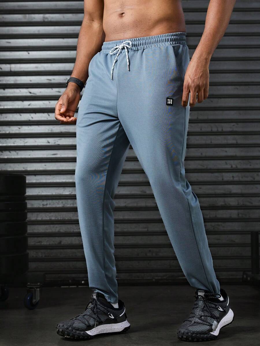 Manfinity Sport Corelite Men's Letter Printed Drawstring Waist Pocket Sports Pants Workout Clothes Running Pants