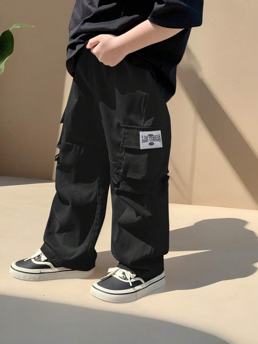 SHEIN 1pc Young Boy Casual Hip Cool Hip Hop Style Loose Windbreaker Material Large Patch Pockets Woven Mark Design Street Retro College Style Wide Leg Pants - Black - View 1