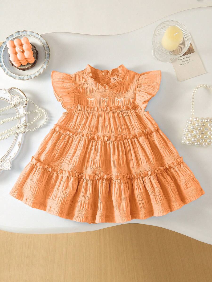 SHEIN Babygirl Summer Light Blue Sweet Bow Embroidered Cake Dress, With Little Flutter Sleeves And Ruffled Collar Design, A Perfect Blend Of Elegance And Cuteness. The Bow Embroidery On The Chest Adds A Touch Of Playfulness. Ideal For Sunny Summer Outings, Perfect For Lounging At Home, And Attending Family And Friends' Parties, Making It The Ultimate Choice For Various Occasions. - Orange - View 1