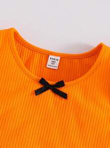 SHEIN Parte superior de tirantes con lazo frontal en estilo casual de calle para niñas preadolescentes