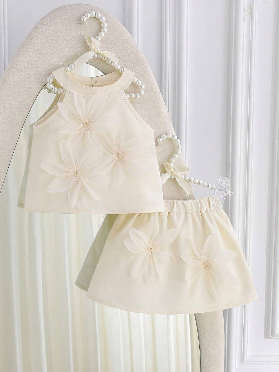 Souflis Souflis 女宝宝纯色3D花朵吊带背心+A字裙两件套。3D花朵的点缀，更添童趣。剪裁修身又舒适。吊带背心搭配A字裙，更能展现小女孩的甜美与活泼。无论是活力四射的运动会，还是亲朋好友的聚会，宝宝都能成为最闪亮的焦点。百搭百搭，适合各种场合。 - 杏色 - 查看 1