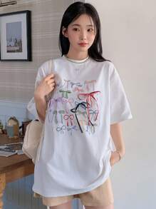 DAZY Camiseta de verano con cuello redondo, lazo impreso, camiseta oversize con estampado gráfico, camiseta casual para mujer/niña