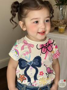 SHEIN Baby Girl Casual Cute Graffiti Cartoon Smiling Face, Bow Print Short Sleeve Crew Neck Top, Suitable For Summer - Multicolor - View 1