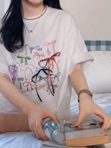 DAZY Camiseta de verano con cuello redondo, lazo impreso, camiseta oversize con estampado gráfico, camiseta casual para mujer/niña