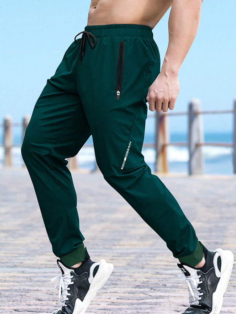 Gym Rark 男士深绿色长款运动裤,带拉链口袋和弹性裤脚,秋季透气运动裤,适合健身穿着。 - 墨綠色 - 查看 1