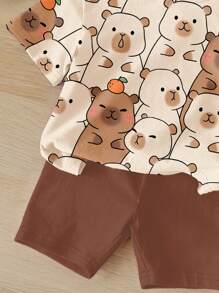 SHEIN Set de 2 piezas de camiseta de manga corta holgada y shorts con estampado de capibara lindo e informal para niñas, adecuado para verano
