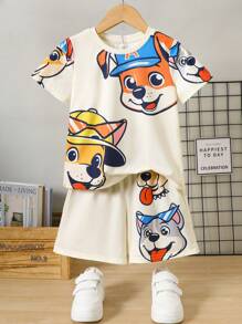 SHEIN Conjunto informal de 2 piezas de pijama de verano para niño con camiseta de manga corta con gráfico de cachorrito lindo y pantalones cortos de punto - Amarillo - Ver 1
