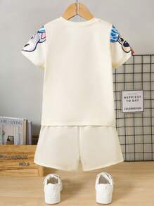 SHEIN Conjunto informal de 2 piezas de pijama de verano para niño con camiseta de manga corta con gráfico de cachorrito lindo y pantalones cortos de punto - Amarillo - Ver 2