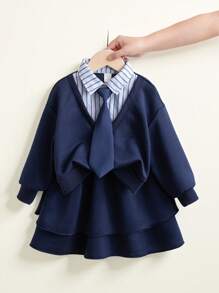 SHEIN Genkimix Kids Young Girl 2 In 1 Outfit With Shirt Collar Sweatshirt And Layered Skirt. The Blouse Features A Shirt Collar Design, Simple And Generous, Paired With A Necktie Decoration For A Playful And Elegant Look. The Skirt Adopts An A-Line Layered Design, Light And Flowy, With The Hem Swaying In The Wind As You Walk, Showcasing The Liveliness And Vibrancy