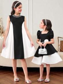 Vestido midi de niña con mangas abullonadas, bloque de color blanco y negro, bajo asimétrico y decoración de flores 3D. Adecuado para uso diario, reuniones familiares y ocasiones especiales