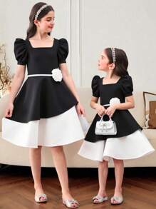 Vestido midi de niña con mangas abullonadas, bloque de color blanco y negro, bajo asimétrico y decoración de flores 3D. Adecuado para uso diario, reuniones familiares y ocasiones especiales