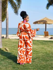 Slaydiva Elegantes romantisches Jumpsuit mit Blumenmuster und Bindedetail in Große Größen, Frühlings- und Sommerbekleidung für Frauen, formelle orangefarbene Hosen für Urlaubsoutfits von Frauen, Resort-Bekleidung