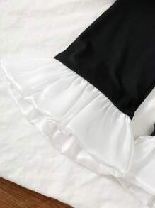 Set de 2 piezas de moda elegante y dulce para niñas de 4 a 7 años, que incluye 1 pieza de blusa sin mangas con panel de punto negro, volantes de organza brillante color albaricoque y detalles florales, y 1 pieza de pantalón negro con cintura elástica y volantes, adecuado para primavera/verano, diario, exterior, viaje, eventos nocturnos, ceremonia y aniversario de cumpleaños