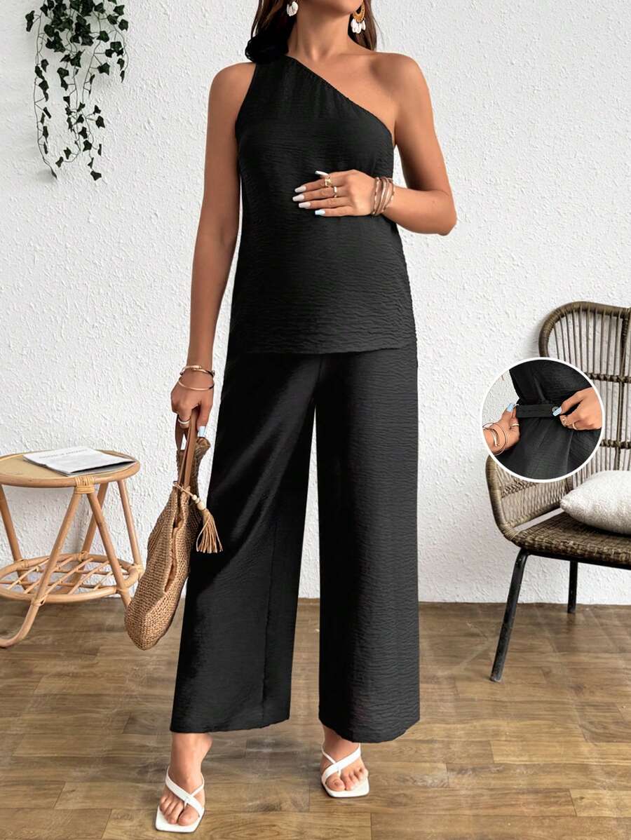 SHEIN Conjunto de 2 piezas de top corto sin mangas y pantalones con decoración floral 3D en unicolor de estilo vacacional para maternidad - Negro - Ver 1