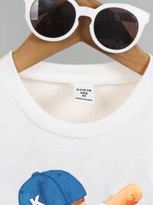 SHEIN 2pcs/Set Young Boy Funny Graphic Print Top And Distressed Shorts. The Pattern Is Fun And Lively, With Excellent Denim Washing Technique. The Stylish Design And Comfortable Crew Neck T-Shirt Make It Suitable For Summer. The Simple And Fashionable Design Showcases The Personalized Of Boys Aged 4-7 For Casual Daily Wear.