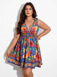 Maija Vestido corto de verano para mujer de tallas grandes, con estampado floral sobre fondo azul, escote en V, tirantes y nudo.