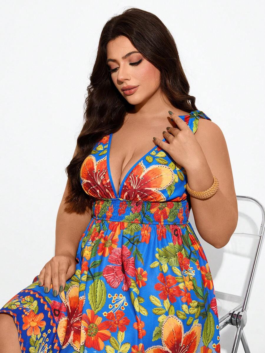 Maija Vestido corto de verano para mujer de tallas grandes, con estampado floral sobre fondo azul, escote en V, tirantes y nudo.