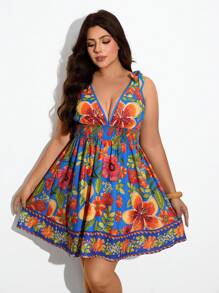 Maija Vestido corto de verano para mujer de tallas grandes, con estampado floral sobre fondo azul, escote en V, tirantes y nudo.