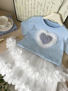 SHEIN 2 pezzi Set bambina - maglietta a maniche corte con scollo tondo e cuore 3D + gonna a ruota stile torta. Design elegante a cuore 3D, gonna a ruota stile torta, adatta per gioco all'aperto, casual a casa, attività scolastiche, feste di compleanno e altre occasioni, permettendo alla tua piccola principessa di godersi l'estate gioiosa! - Multicolore - Visualizzare 2