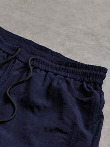 Manfinity Sport Corelite Pantalones largos informales de hombre con cintura elástica con cordón y estampado