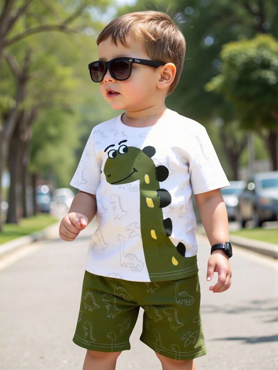 SHEIN Playful Pals 1 set de camiseta de manga corta con estampado de dinosaurio de dibujos animados y pantalones cortos para niños pequeños, ligero para uso diario, adecuado para primavera/verano